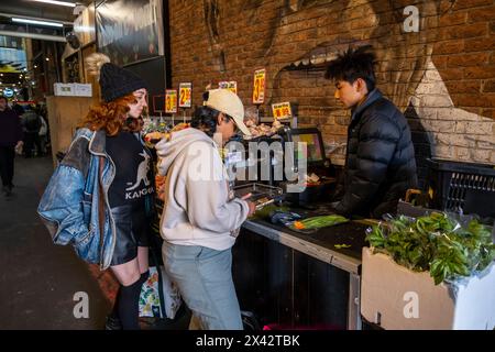 Shoppers at the South Melbourne market. The market is an inner city landmark and favorite of tourists. South Melbourne, Victoria, Australia. Stock Photo