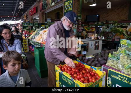 Shoppers at the South Melbourne market. The market is an inner city landmark and favorite of tourists. South Melbourne, Victoria, Australia. Stock Photo