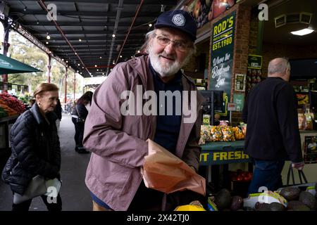 A man shopping at the South Melbourne market. The market is an inner city landmark and favorite of tourists. South Melbourne, Victoria, Australia. Stock Photo