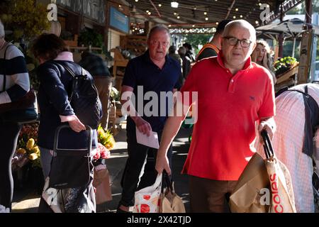 Shoppers at the South Melbourne market. The market is an inner city landmark and favorite of tourists. South Melbourne, Victoria, Australia. Stock Photo