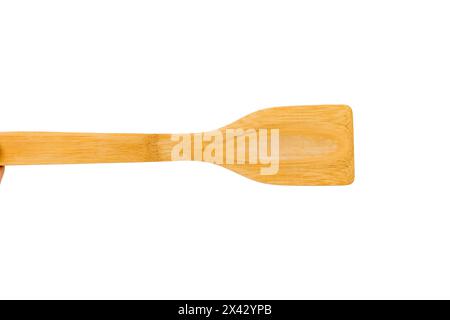 Kitchen spatula made of natural wood. Use for cooking on non-stick pans. Isolated on a white background. Close-up. Stock Photo