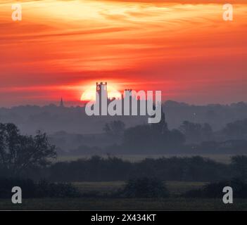 Sunrise behind Ely Cathedral, as seen from Haddenham Stock Photo