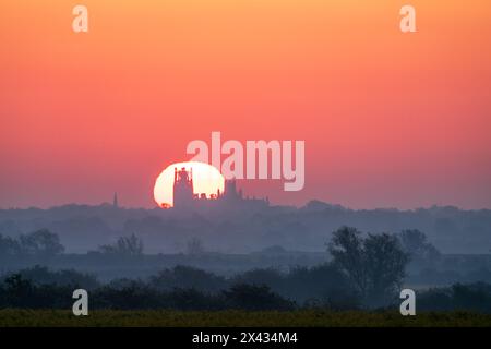 Sunrise behind Ely Cathedral, as seen from Haddenham Stock Photo