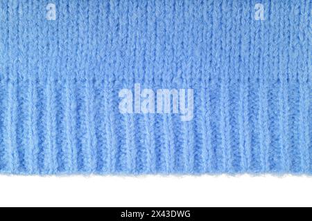 Blue knitted woolen jersey fabric, sweater, pullover texture with edge isolated on white background. Fabric abstract backdrop, cloth wallpaper Stock Photo