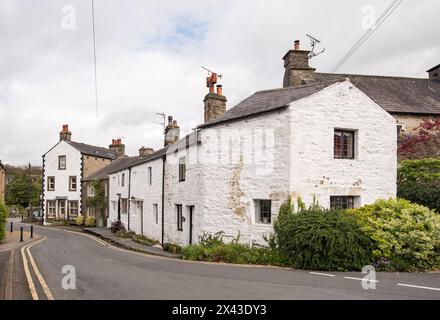 Looking back along Church St Giggleswick towards St Akeldas & The Market Cross. North Yorkshire village located close btythe market town of Settle. Stock Photo