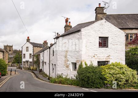 Looking back along Church St Giggleswick towards St Akeldas & The Market Cross. North Yorkshire village located close btythe market town of Settle. Stock Photo