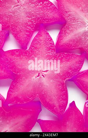 Top View of Sliced Fresh Star Fruits in Surreal Pop Art Styled Orchid Purple for Backdrop and Banner Stock Photo