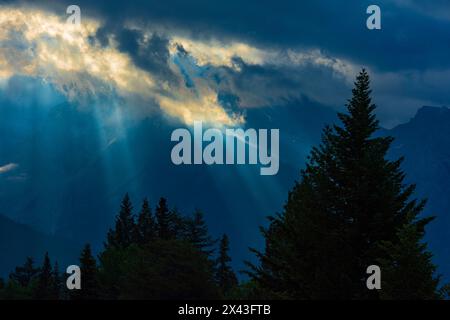 Canada, Alberta, Waterton Lakes National Park. Sunburst through storm clouds. Stock Photo