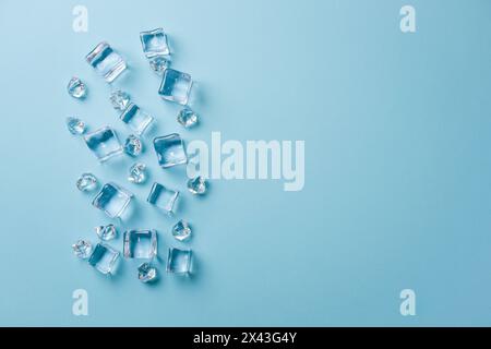 top view of ice cubes of different sizes on blue background Stock Photo