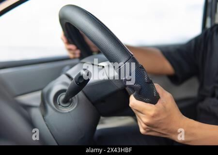 Closeup image of male driver hands holding steering wheel. Stock Photo