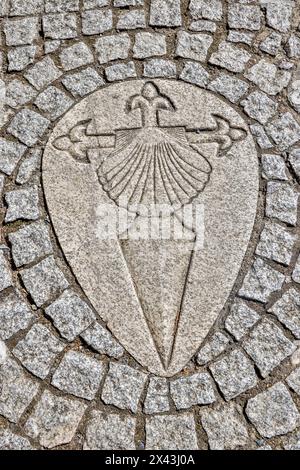 Spain, Galicia. Sword of the Knights Templar and clam shell in the path along the Camino de Santiago between Ventras de Naron and Palas de Rei Stock Photo