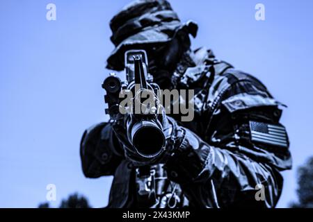 Ready soldier aiming a rifle in studio Stock Photo - Alamy