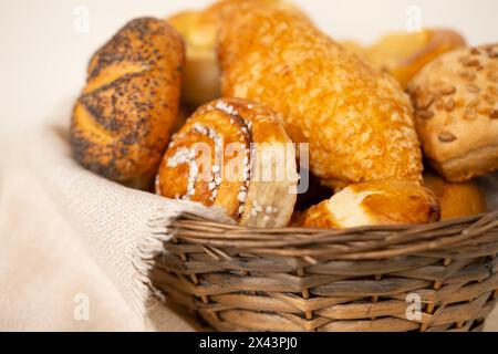 delightful assortment of freshly homemade baked pastries, including cheese buns, poppy seed buns, rolls, savory pretzels and sweet curd tarts in tradi Stock Photo