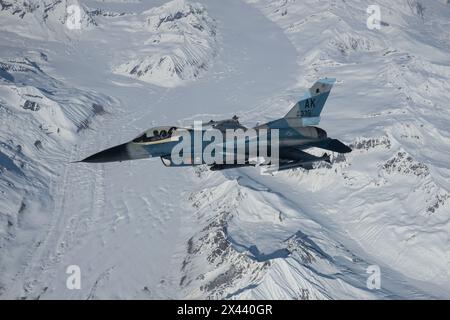 A U.S. Air Force F-16 Fighting Falcon, assigned to the 354th Fighter Wing, Eielson Air Force Base, Alaska, flies over the Joint Pacific-Alaska Range C Stock Photo