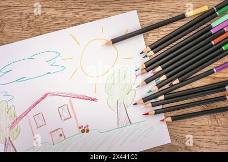 colored pencils next to a drawing painted with the pencils Stock Photo