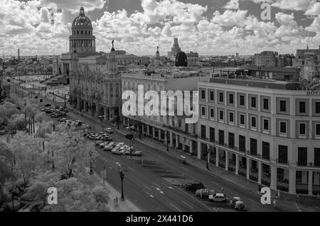 An infrared picture looking down across Parque Central towards the Capitol with Classic American cars lining the streets, Havana, Cuba. Stock Photo