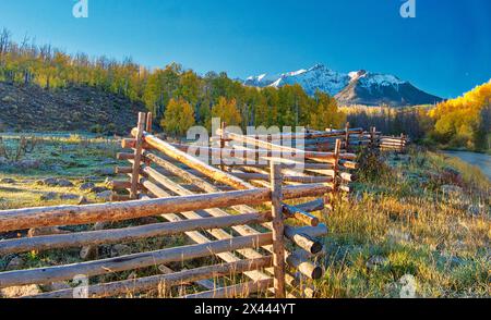 USA, Colorado, Quray. Dallas Divide, sunrise on the Mt. Snaffles with autumn colors and split rail fence Stock Photo