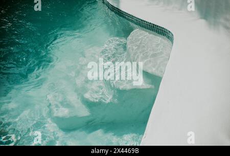 Details of stairs of a home swimming pool. Design and detail of stairs of a home pool Stock Photo
