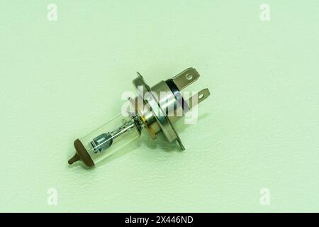 Automobile halogen headlamp bulb isolated on textured background Stock Photo