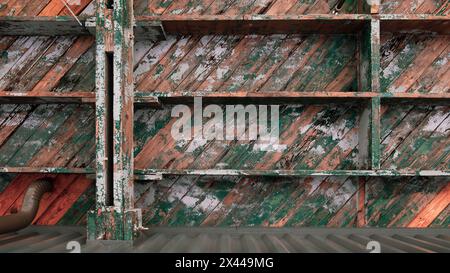 Peeling paint on very old ceiling joists Stock Photo