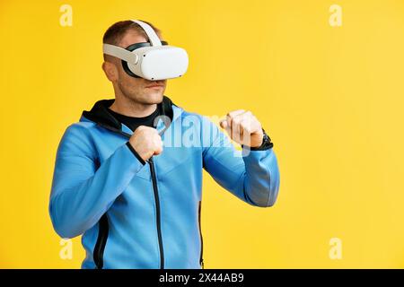 Man wearing virtual reality goggles doing shadow boxing over yellow background Stock Photo