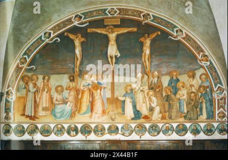 ANGELICO, Fra (b. ca. 1400, Vicchio nell Mugello, d. 1455, Roma)  Crucifixion and Saints 1441-42 Fresco, 550 x 950 cm Convento di San Marco, Florence  The giant fresco occupies the entire wall opposite to the entrance of the Chapter Room. The saints depicted are, from the left: Cosmas and Damian, Lawrence, Mark the Evangelist, John the Baptist, the Virgin and the pious women; to the right of the Cricifixion kneeling Dominic, Jerome, Francis, Bernard, John Gualberto and Peter the Martyr, standing Zanobi (or perhaps Ambrose), Augustin, Benedict, Romuald and Thomas of Aquino. Around the fresco, o Stock Photo