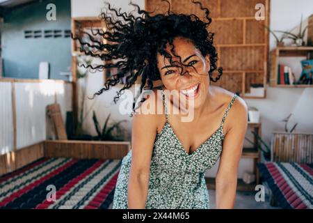 Portrait of happy woman with tossed hair dancing at wellness resort Stock Photo
