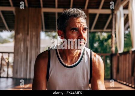 Thoughtful mature man looking away at wellness resort Stock Photo