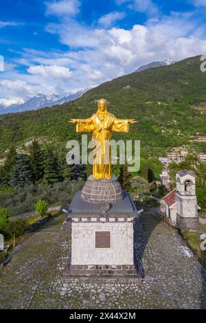 Aerial view of the golden statue of the colossus of Cristo Re. Bienno, Brescia province, Valcamonica valley, Lombardy, Italy, Europe. Stock Photo