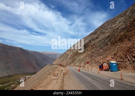 Traffic guard and controls at roadworks widening the Pan American Highway / Ruta 5 in the Camarones Valley near Cuya, Chile Stock Photo