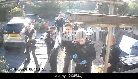 RETRANSMITTED AMENDING BYLINE NUMBERPLATE PIXELATED BY PA PICTURE DESK Handout footage from a doorbell camera of police officers after tasering and detaining a sword-wielding man in Hainault, north east London, after a 14-year-old boy died after being stabbed following an attack on members of the public and two police officers. Picture date: Tuesday April 30, 2024. Stock Photo