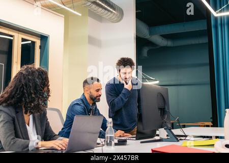 Group of people working with laptop in a coworking Stock Photo