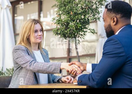 Two multiracial business people shaking hands closing a business deal Stock Photo