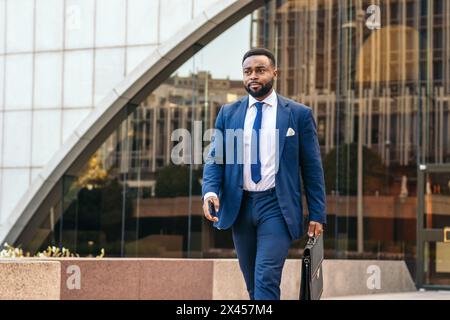 Business black man in suit leaving the office holding his work briefcase Stock Photo