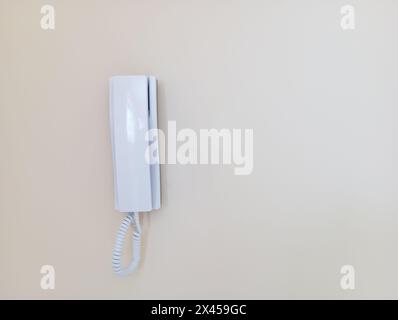 Simple intercom on white wall. Stock Photo