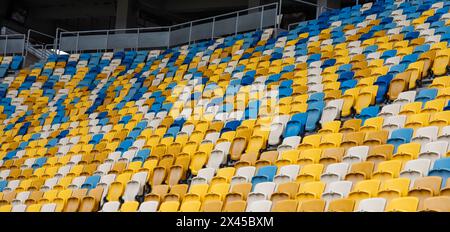 empty colorful seats on tribunes of stadium. Stock Photo