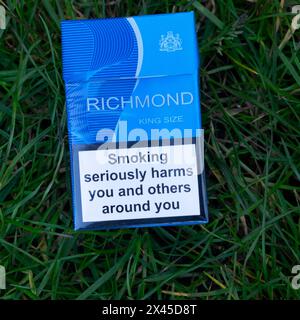 Packet of Richmond tobacco cigarettes cigarette health warning 'Smoking seriously harms you and others around you' on grass background Britain UK 2024 Stock Photo