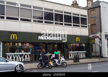 Uxbridge, UK. 27th April, 2024. A food delivery drivers outside a McDonald's Restaurant in Uxbridge in the London Borough of Hillingdon. Credit: Maureen McLean/Alamy Stock Photo