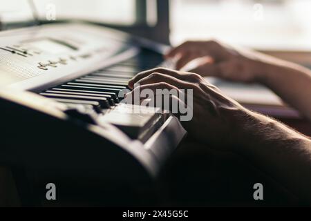man hands playing the piano close-up. musical keyboard Stock Photo