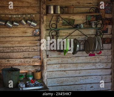 Well used kitchen utensils hanging on the walls in the farmhouse at a coffee farm near Vinales, Cuba Stock Photo