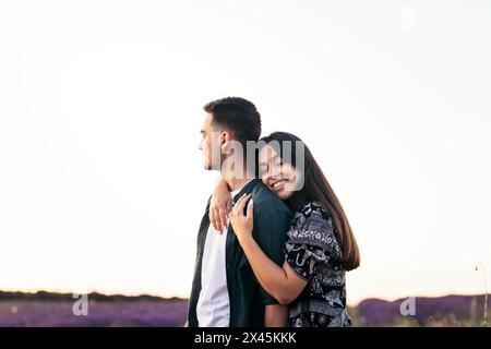 Young couple in love enjoying a day at the countryside in a lavender field Stock Photo