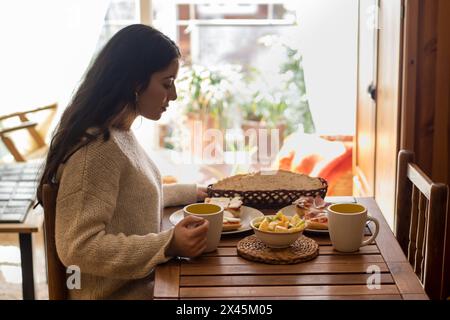 Beautiful woman having breakfast at home Stock Photo