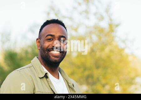 smiling afro american young man portrait in a park Stock Photo