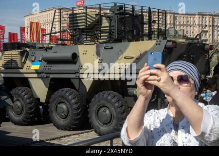 Moscow, Russia. 30th of April, 2024. A woman takes selfie on Moscow's Poklonnaya Hill where military hardware captured by Russian servicemen in the zone of Russia's special military operation, in Moscow, Russia Stock Photo