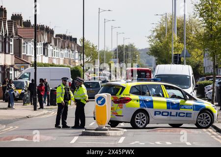 Police and other emergency services in Hainault, east London, at a serious incident in which a man with a sword was arrested after attacking people. Stock Photo