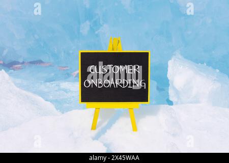 Customer onboarding symbol. Concept words Customer onboarding on beautiful yellow black blackboard. Beautiful blue ice background. Business Customer o Stock Photo