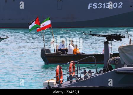 April 29, 2024, Persian Gulf, Bushehr, Iran: Iranian speedboats of the Basij Resistance Mobilization Force, a paramilitary volunteer militia within the Islamic Revolutionary Guard Corps (IRGC) and one of its five branches, are sailing along the Persian Gulf as waving the Iran and Palestine flags during the IRGC marine parade to commemorate Persian Gulf National Day near the Bushehr nuclear power plant in the seaport city of Bushehr, Bushehr province, southern Iran. Iran celebrates the anniversary of the liberation of the country's south from Portuguese occupation in 1622 as 'Persian Gulf Natio Stock Photo