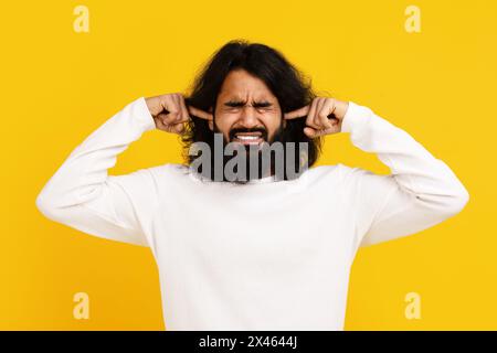 Man With Long Hair and Beard Holding Hands on Ears Stock Photo