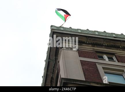 New York, United States. 30th Apr, 2024. The flag of Palestine is waved from the roof of Hamilton Hall of Columbia University in New York City on Tuesday, April 30, 2024. Pro-Palestine student demonstrators occupied the Hamilton Hall building overnight and have refused to vacate the premises. Photo by Louis Lanzano/UPI Credit: UPI/Alamy Live News Stock Photo