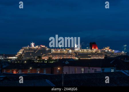 30 April 2024. Southampton, UK. Cunard's brand new luxury Cruise ship, the Queen Anne after arriving at Mayflower Cruise Terminal, berth 106, pictured here illuminated by lights at night. The Queen Anne cruise liner will depart on her maiden voyage from Southampton to Lisbon on May 3, 2024 Stock Photo